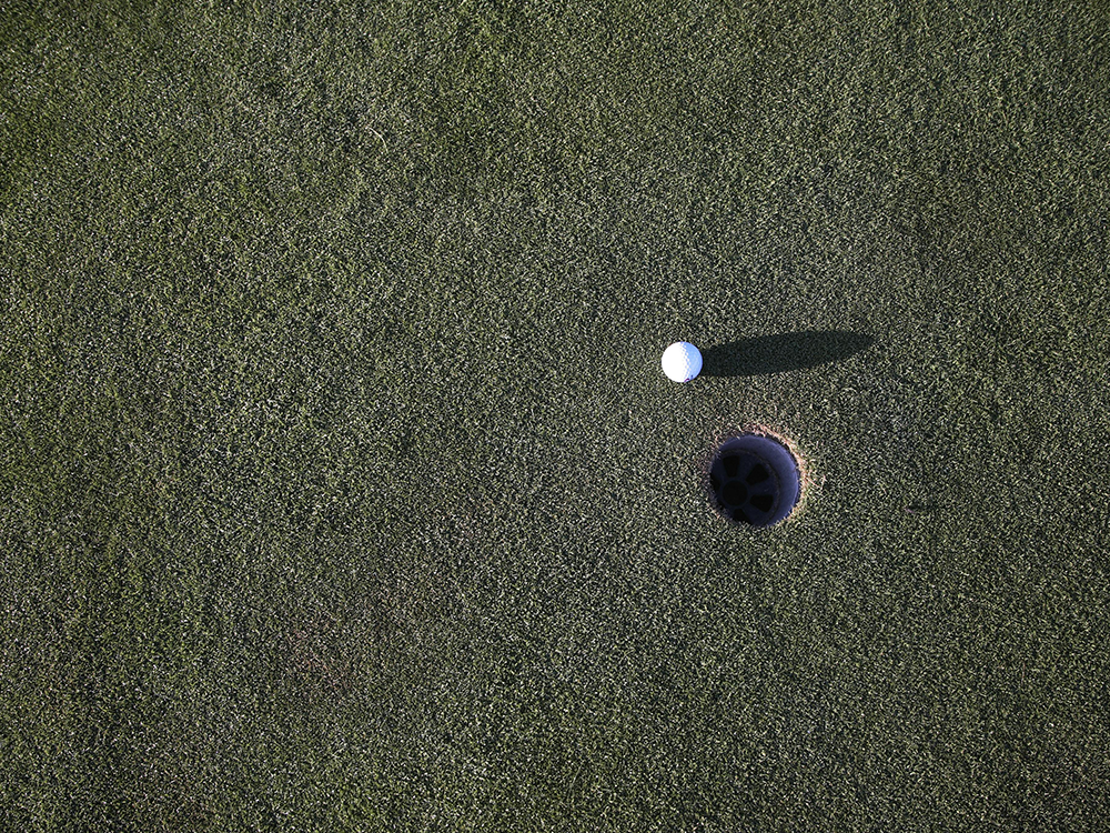 STOCK IMAGE - AERIAL VIEW OF GOLF BALL NEAR HOLE